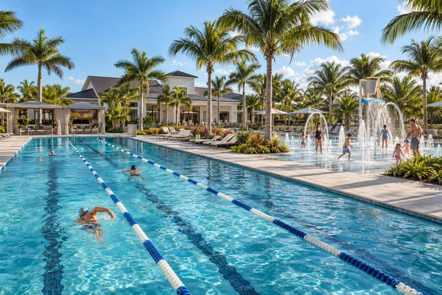Lap pool with marked swim lanes beside a splash park where children play under water jets